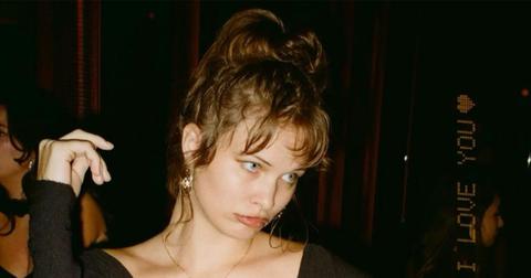 Eva Evans dancing in a club with her hair up.