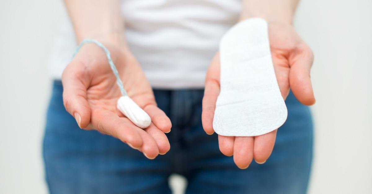 woman holding sanitary napkin and tampon in her hands picture id