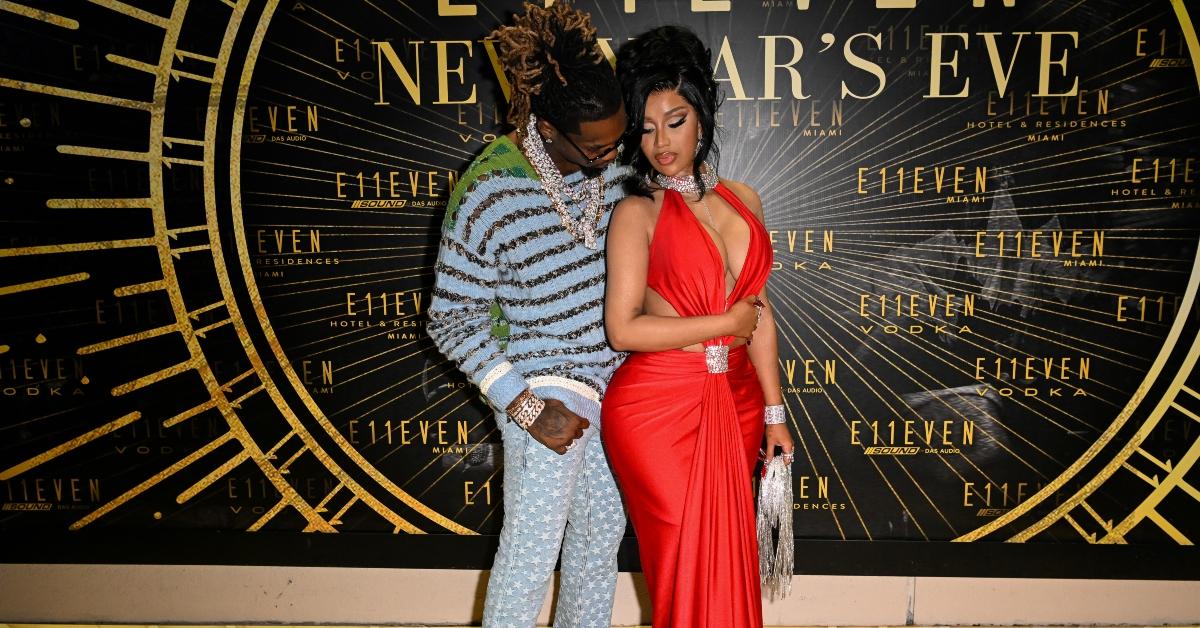 Offset embraces Cardi B. in a red dress.