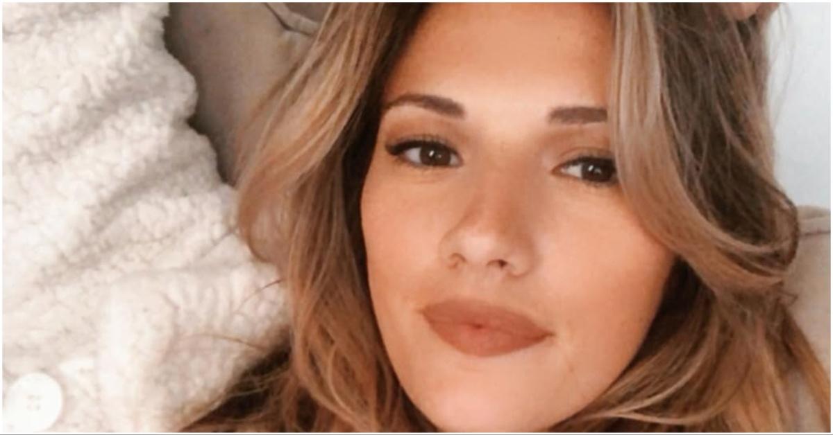 Taryn Hatcher posing for a selfie in her bed