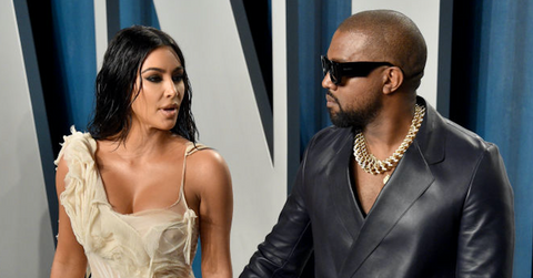 Kanye West and Kim Kardashian posing for photographs.