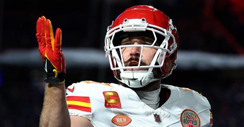 Travis Kelce blowing a kiss during a game between the Chiefs and Bills.