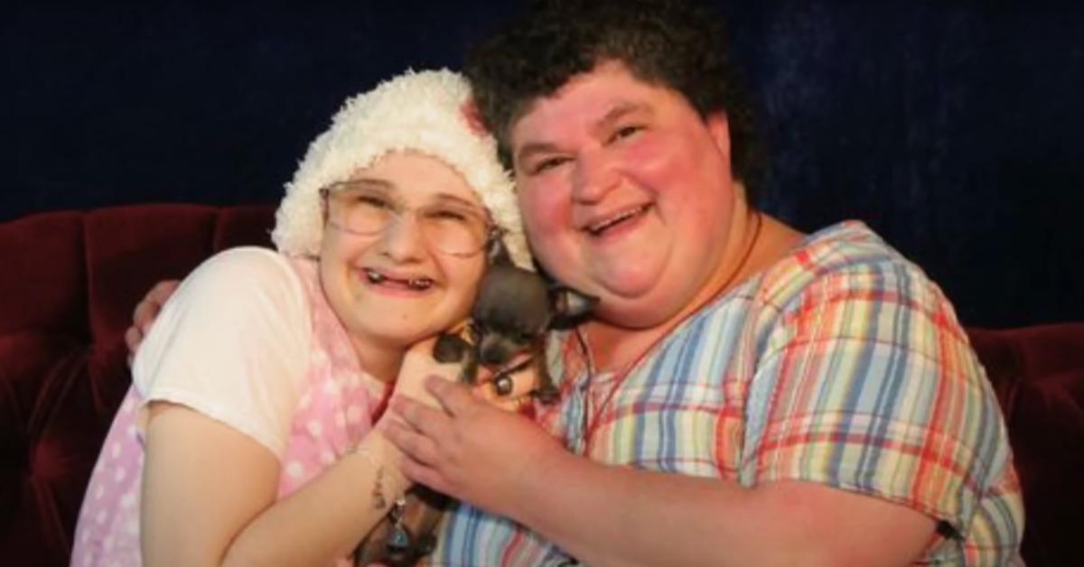 Gypsy Rose Blanchard and Dee Dee Blanchard smile while holding a puppy