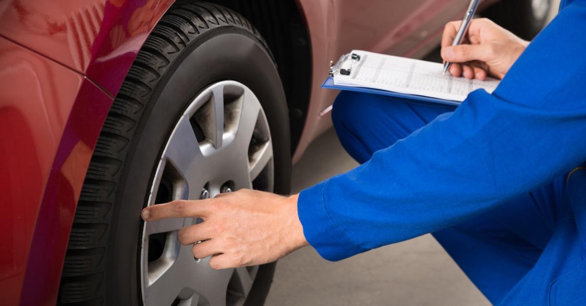 mechanic examining car wheel picture id