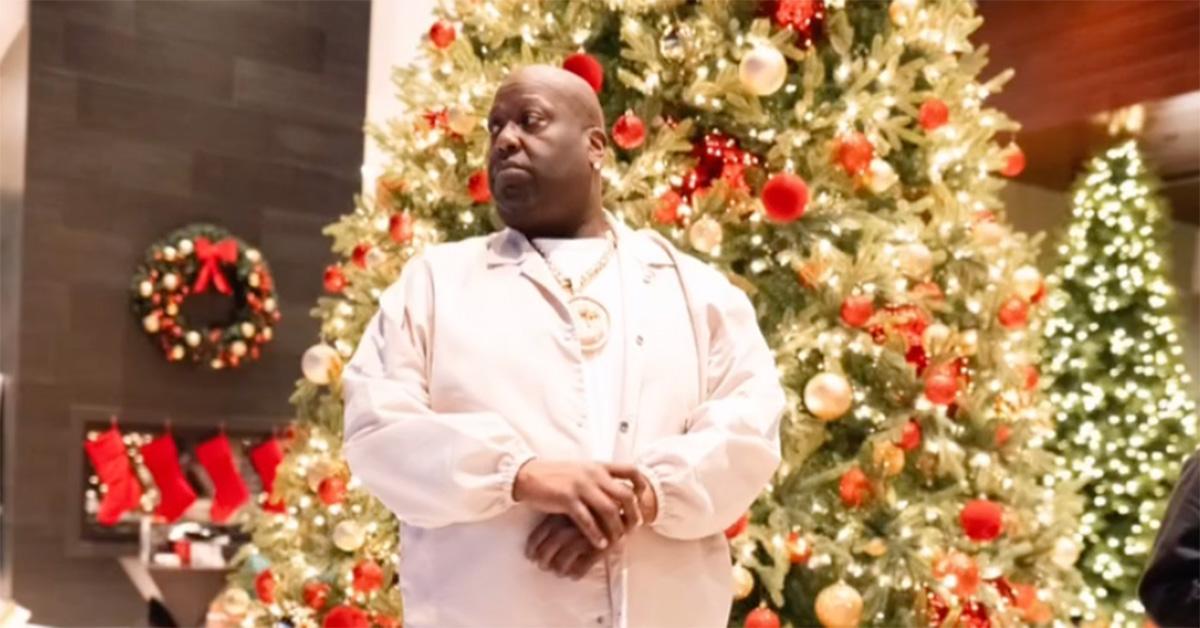 Big Jook standing in front of a Christmas tree. 