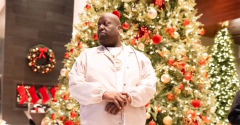 Big Jook standing in front of a Christmas tree.