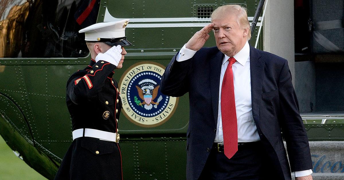 Donald Trump leaving Marine One and saluting a soldier. 