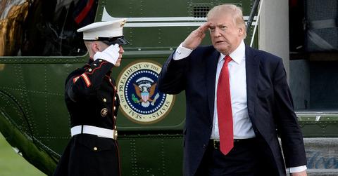 Donald Trump leaving Marine One and saluting a soldier.