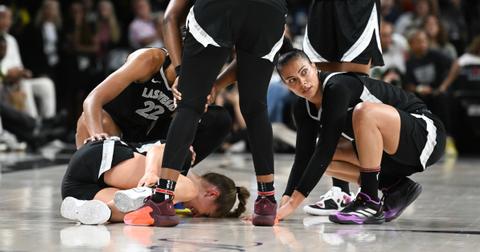A'ja Wilson, Chelsea Gray, and Alysha Clark rush to Kate Marti after being injured in the first half of the the Aces-Sky game at Michelob ULTRA Arena on July 16, 2024.