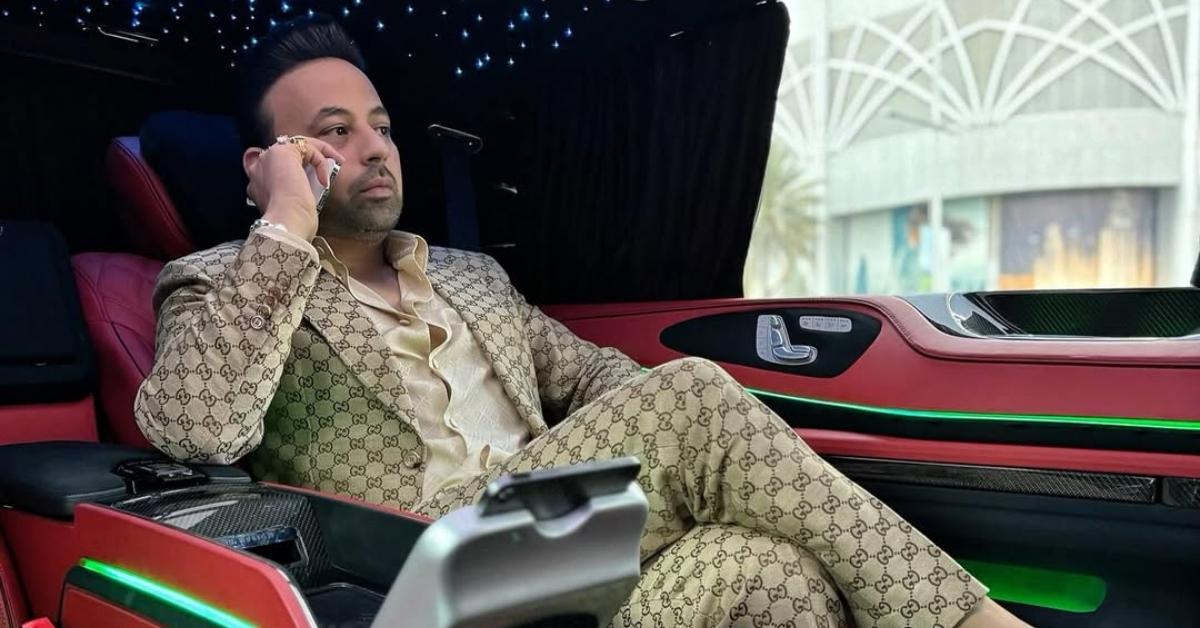 Satish Sanpal talks on his phone in his luxury car.