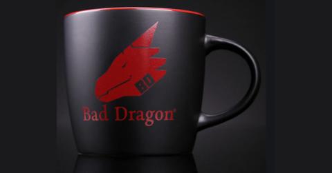 The Bad Dragon coffee mug with its logo visible.