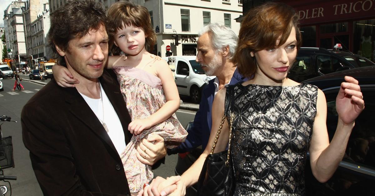 Paul W.S. Anderson  holds Ever Anderson to the left of Mila Jovovich at Paris Fashion Week in 2011