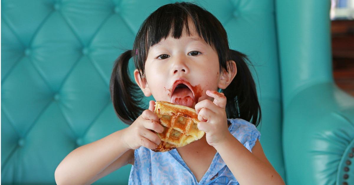 portrait child girl eating ice cream waffles picture id