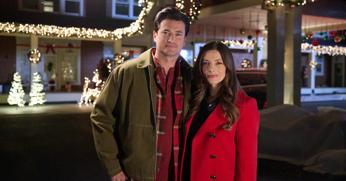 Rose and Brysen in 'Deck the Walls', standing in front of homes with holiday lights