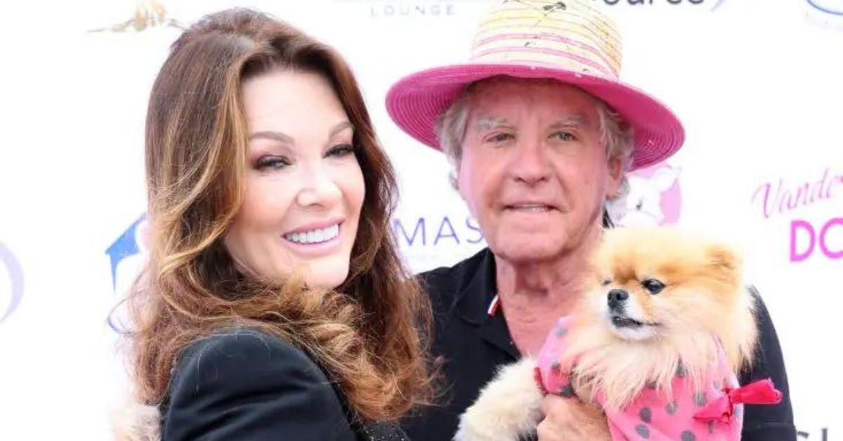 Lisa Vanderpump and Ken Todd holding a Pomeranian dog Vanderpump Dog Foundation red carpet