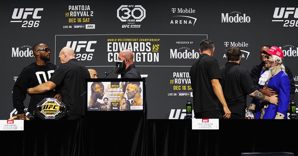 Leon Edwards being held back during a press event with Colby Covington. 