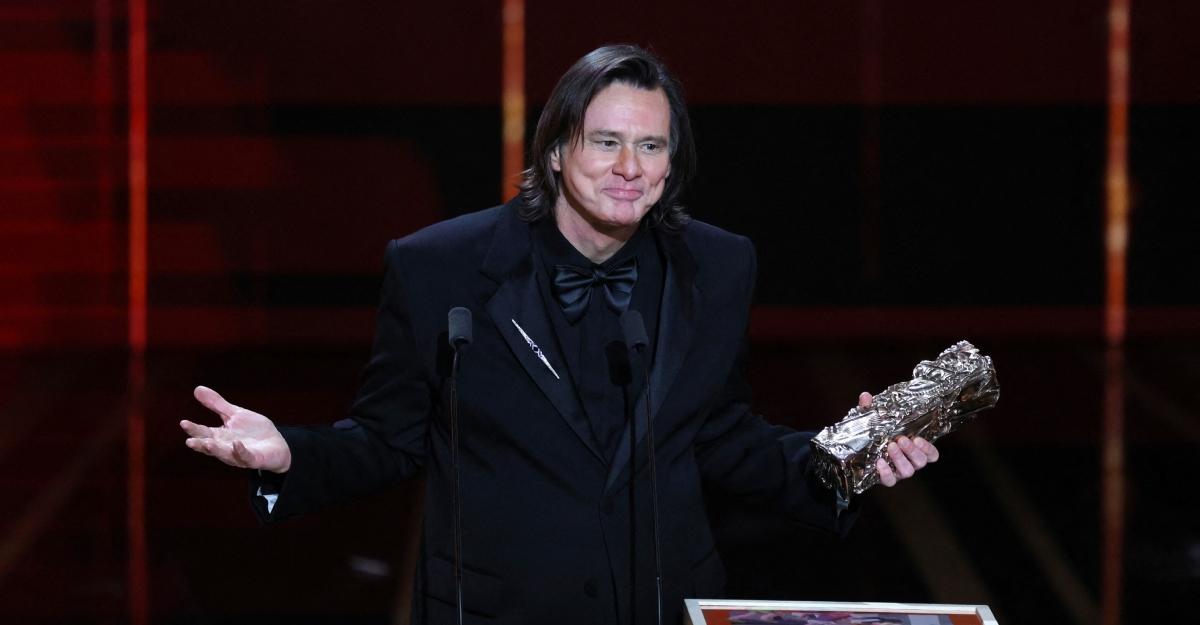 Jim Carrey gestures and makes a face as he accepts his honorary Cesar Award.