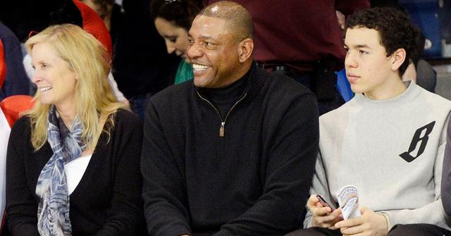 Kristen Rivers, Doc Rivers, and their son Spencer at a game