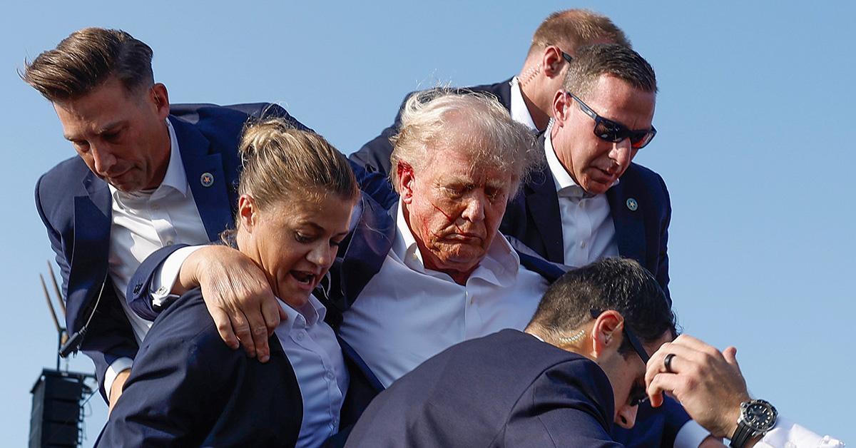 Secret Service agents escorting Trump offstage after he was shot at. 