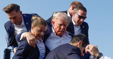 Secret Service agents escorting Trump offstage after he was shot at.