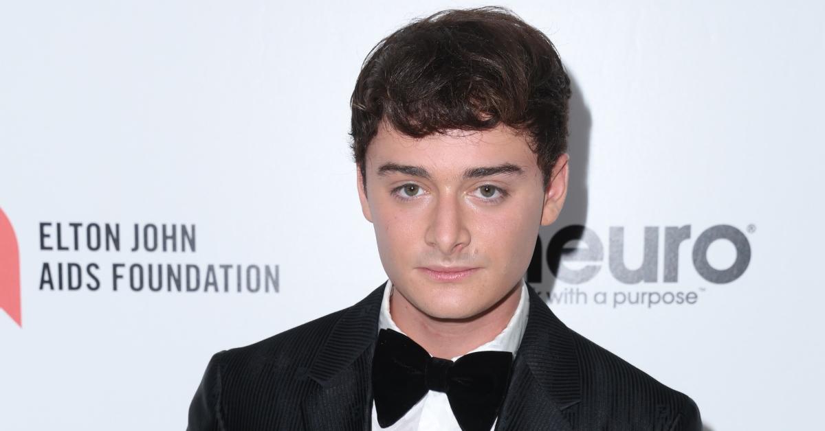 noah schnapp wearing tuxedo on red carpet at 2023 elton john aids foundation academy awards viewing party