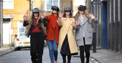 Four women wearing the Oculus virtual reality headsets.