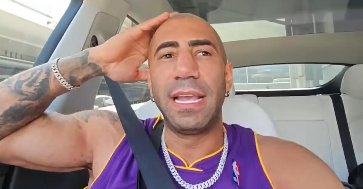 Fousey wearing a purple jersey sitting in a car.