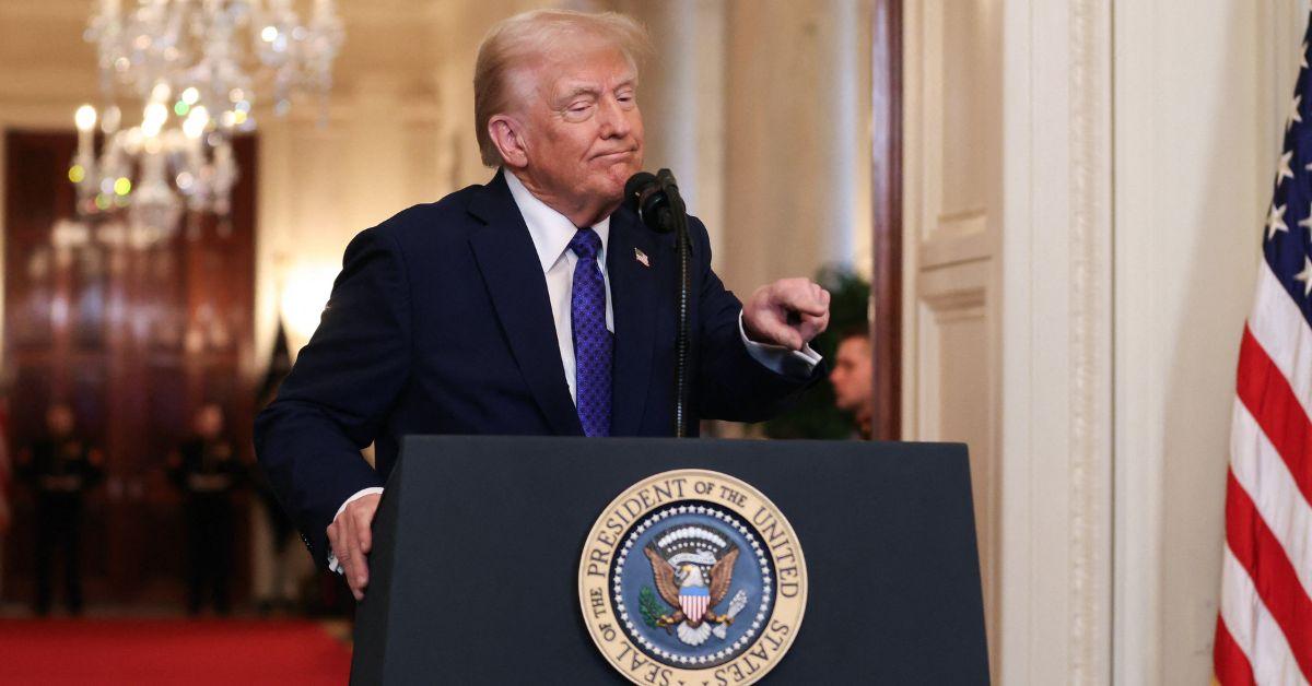 Donald Trump pointing at a podium in the White House. 