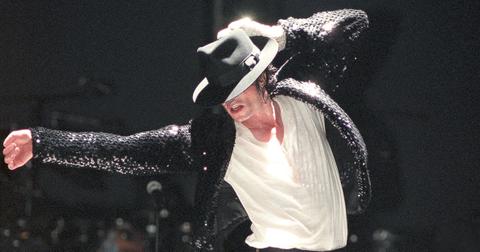 Michael Jackson dancing with his hat over his eyes.