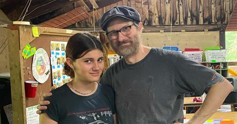 Erik Jensen in a hat with his arm around his daughter.