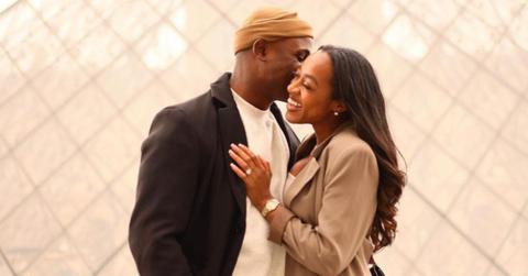 Silas Cooper kissing wife Jasmine Ellis Cooper in front of a photo backdrop
