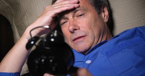 man looking at clock