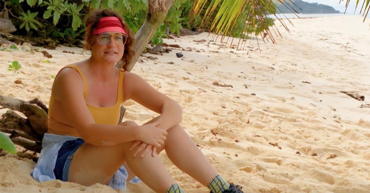 Liz Wilcox during an interview on 'Survivor' in a yellow tank top. 