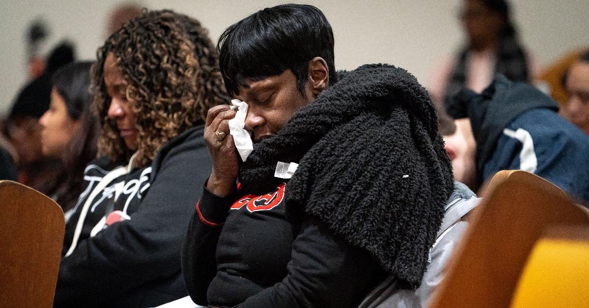 A woman wipes a tear from her eyes during a vigil at Hamilton United Methodist Church