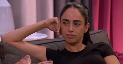 Maria Georgas sports a stressed facial expression in Season 28 of 'The Bachelor' while wearing a black t-shirt and her hair in a ponytail.