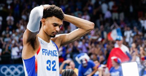 Victor Wembanyama with his hands on his head during the Olympics.