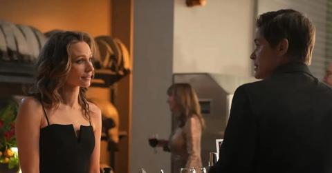 Kendra in a black dress talking to Owen.