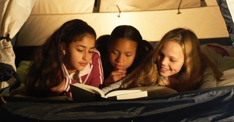 Girls reading together.