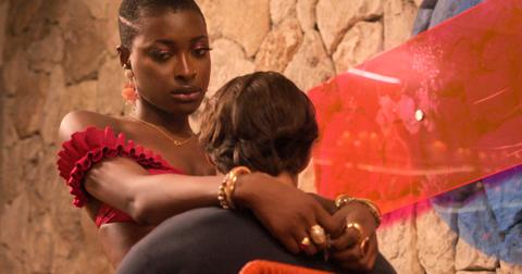 Tolú, with a sad expression on her face, wraps her arms around Chris's shoulders in Season 2 of 'Perfect Match.'