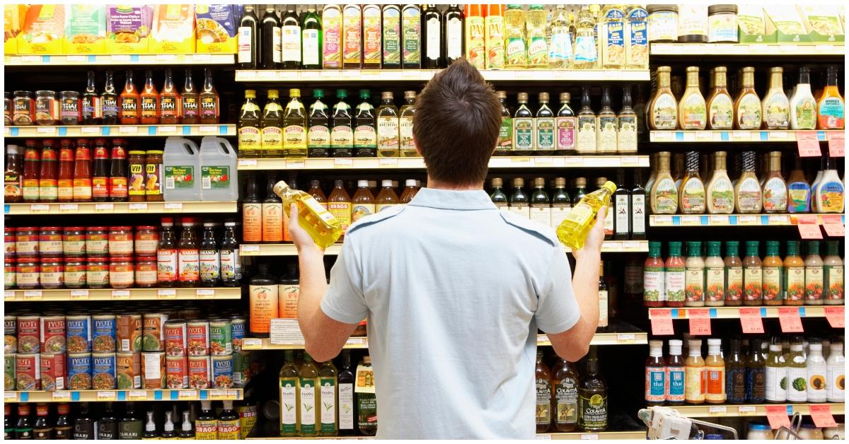 A man buying oil at a grocery store 