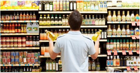 A man buying oil at a grocery store