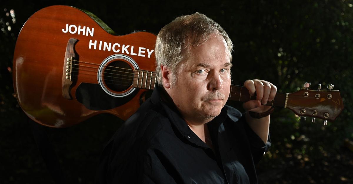 John Hinckley Jr. holds his guitar 