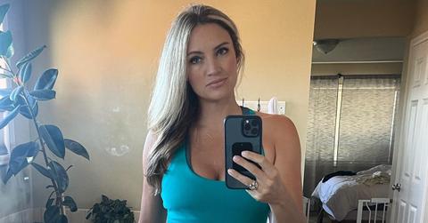 Brandi Bowman from Season 4 of 'Love Is Blind' taking a selfie in a blue dress.