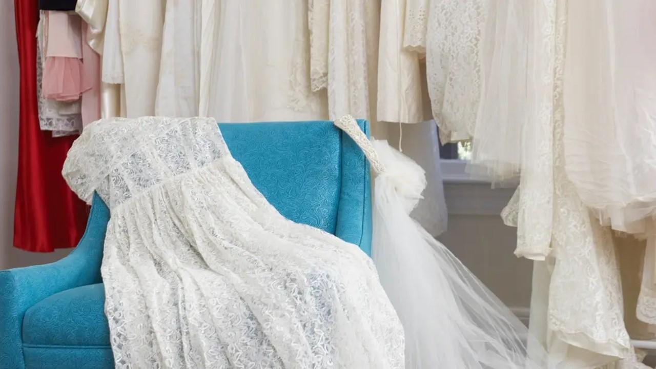 Wedding dress and veil on an armchair in a bridal store 