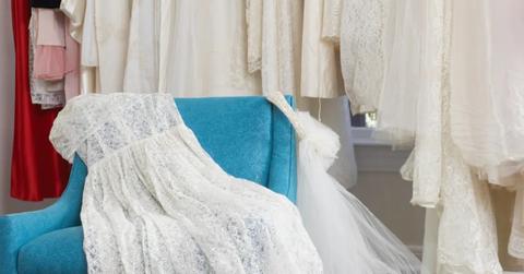 Wedding dress and veil on an armchair in a bridal store