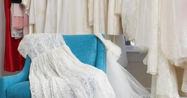 Wedding dress and veil on an armchair in a bridal store