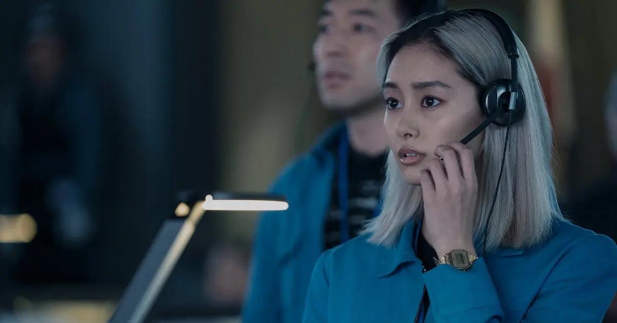 Mitsuki wearing a headset and a blue jacket in Apple TV+ series 'Invasion'