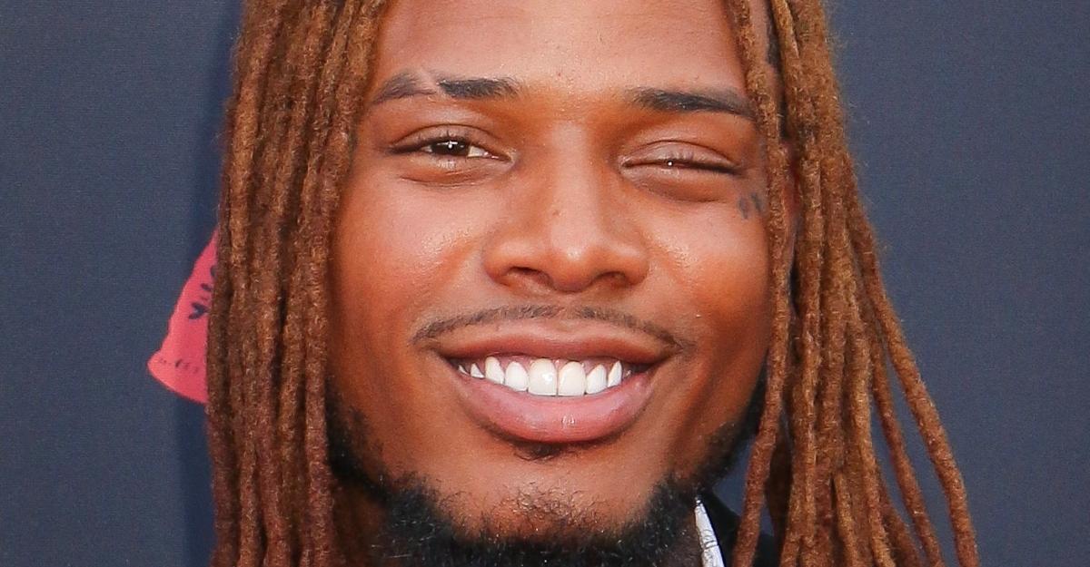 Fetty Wap smiles on a red carpet.