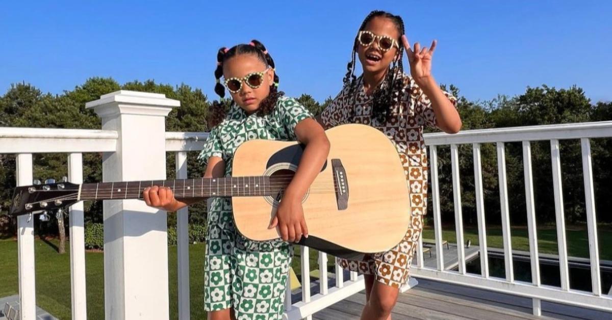 Meena Harris's daughters playing a guitar on their home balcony.