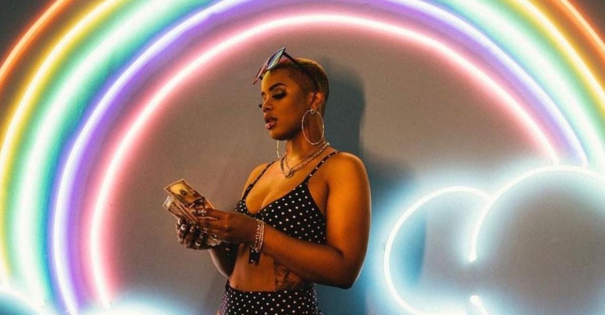 ‘Black Ink Crew’ star Nychelle poses for an Instagram photo in front of a light-up rainbow